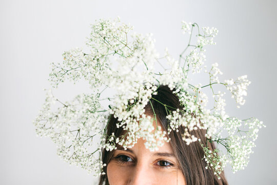 Closeup of a young woman with gypsophila paniculata on head.