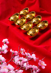 Chinese gold ingots on red background, Chinese text language mean lucky.