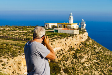 Tourist take photo at lighthouse, Cabo de Gata, Spain