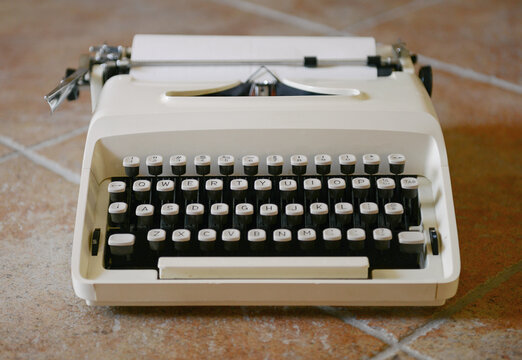 Vintage typewriter sitting on the floor