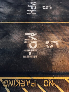 No Parking, 5 MPH signs painted on the street