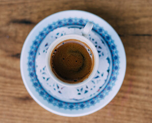 Black coffee served in traditional Turkish cup. Close up. 