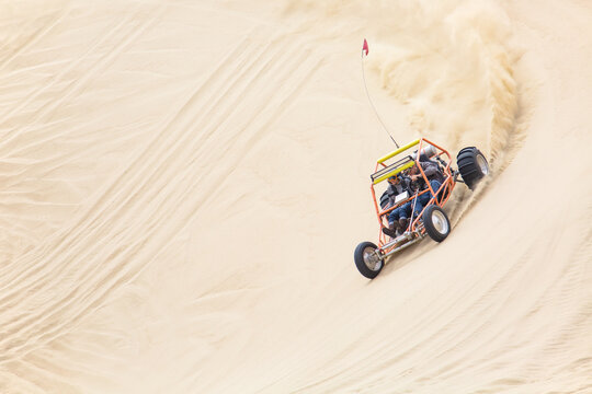 Sand rail racing through the sand dunes
