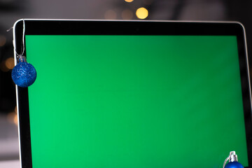 laptop with green screen - chromakey near New Year's decorations. christmas theme. template. 