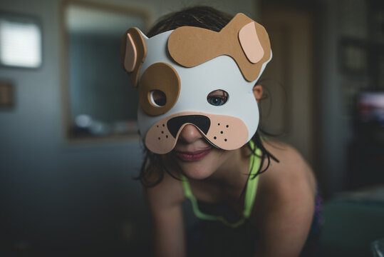playing make believe in a Bulldog mask
