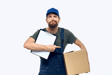 Man in working uniform box delivery loader courier light background