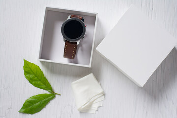 Close up cleaning modern smartwatch with microfiber cloth.