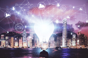 Multi exposure of bulb hologram drawing and cityscape background. Concept of idea.