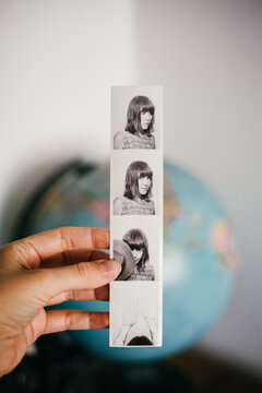 Hand holding photobooth strips