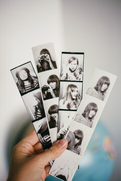 Hand holding photobooth strips