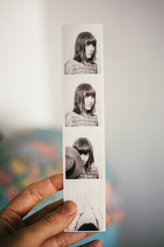 Hand holding photobooth strips