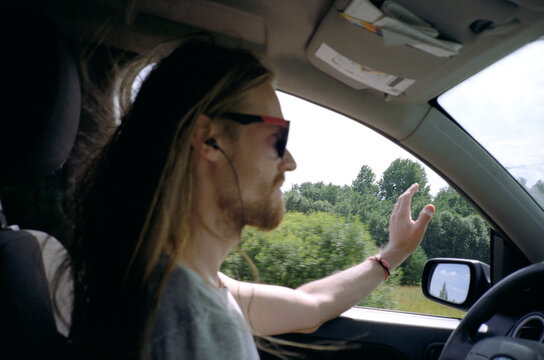 Young man enjoying road trip during summer vacation