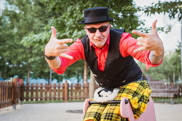 Weird man with bowler hat over a children's toy, man wearing kilts and Scottish style clothes has...