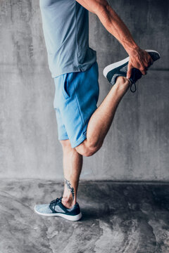 Man Stretching His Leg After a Workout