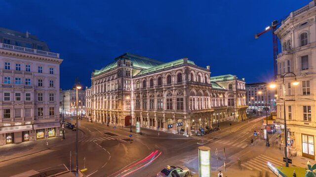 Beautiful view of Wiener Staatsoper (Vienna State Opera) aerial day to night transition timelapse in Vienna, Austria. Illuminated historic buildings and traffic on streets