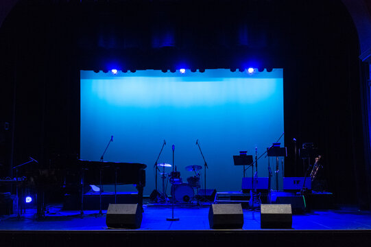 Empty concert stage bathed in blue light - Powered by Adobe