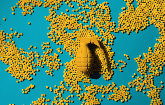 Yellow hand grenade with yellow shells -ball shaped on blue background .