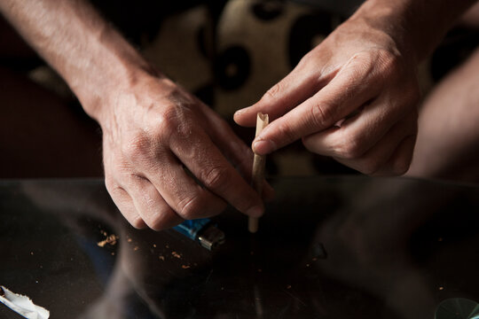 Close up of Hands of a man making a joint.