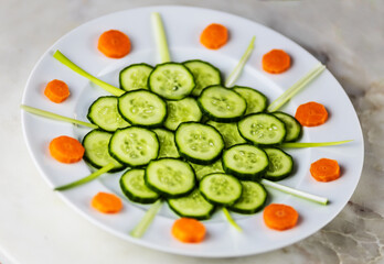 cucumber and carrot slices with chives on white plate