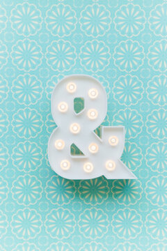 Ampersand marquee light on a blue background
