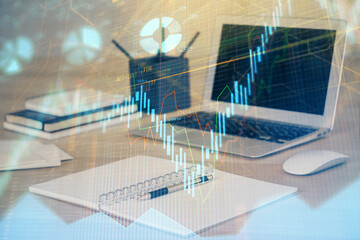 Forex market chart hologram and personal computer background. Multi exposure. Concept of investment.