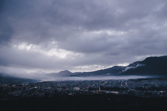 Dawn light over a city near the mountains