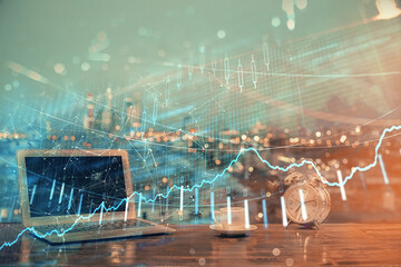 Financial graph colorful drawing and table with computer on background. Multi exposure. Concept of international markets.