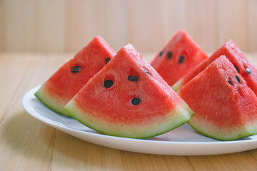 closeup slice pieces of refreshing watermelon on a wooden background