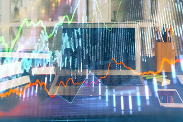 Financial graph colorful drawing and table with computer on background. Double exposure. Concept of international markets.