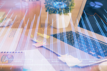 Double exposure of forex graph and work space with computer. Concept of international online trading.