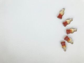 marmalade dessert. gummies in the form of a bottle with black lemonade. an appetizing figurine made from marmalade. semicircular candy shape. sweet dessert