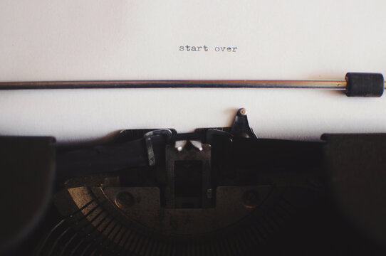 A vintage typewriter that says start over