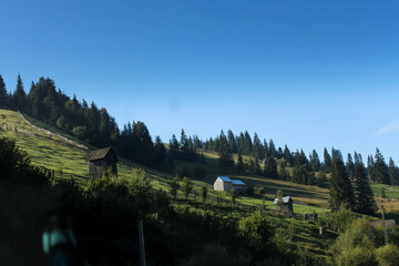 Landscape of moutains with houses and trees in Romania - rural landscape