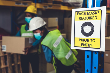 Caution sign in factory warning to industry labor worker to prevent Covid-19 Coronavirus spreading...