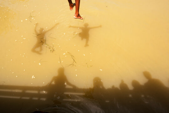 Boys jumping in water in summertime