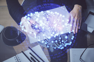 Double exposure of writing hand on background with brain hologram. Concept of learning.