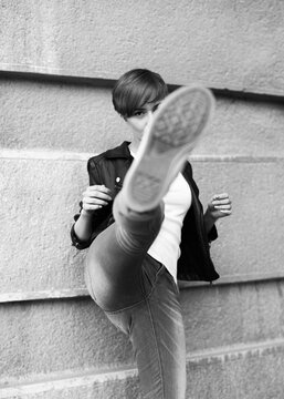 young woman kicking