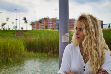 blond girl worried in the park