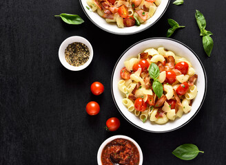 Pasta with bacon, tomato, parmesan cheese and basil leaves