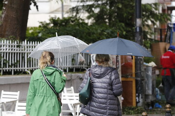 Woman with umbrella walking on a rainy day