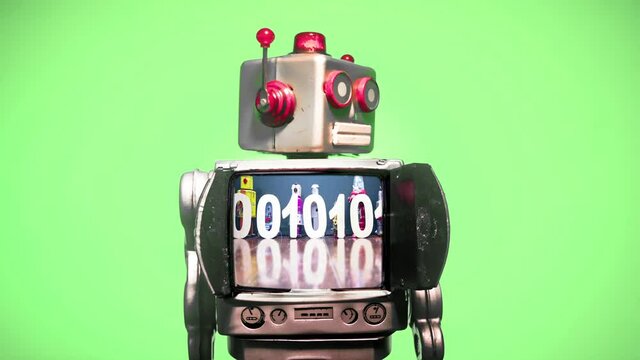 A retro robot with a spinning head  and a  binary code message with a green screen background 