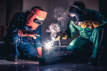 Metal welding steel works using electric arc welding machine to weld steel at factory. Metalwork...