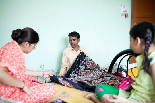 A small businessman selling dress material at home delivary