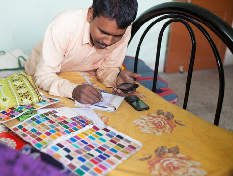 A small businessman preparing hand written bill to customer