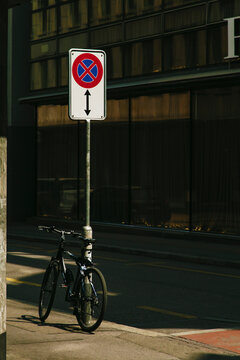 Bicycle leaning against street sign - stopping and parking prohibited
