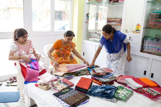 A Businesswoman who sells traditional Indian dress in a small shop