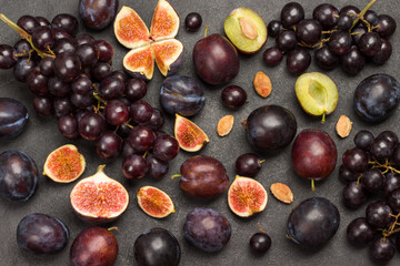 Still life of fruits. Bunch of grapes. Figs and plums