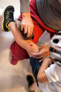 Mom cleaning her son's scraped knee