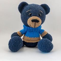 Teddy bear doll Amigurumi handmade sits .