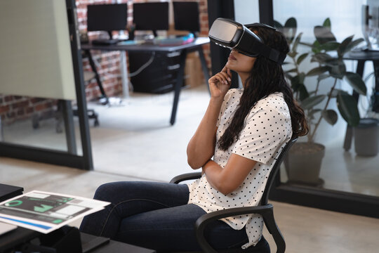 Woman using VR headset at office